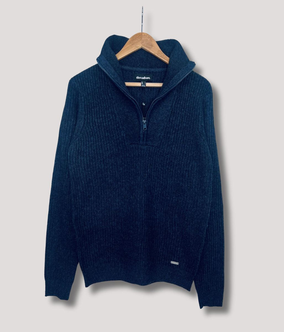 Threadbare Blue sweater on a hanger against a light gray background