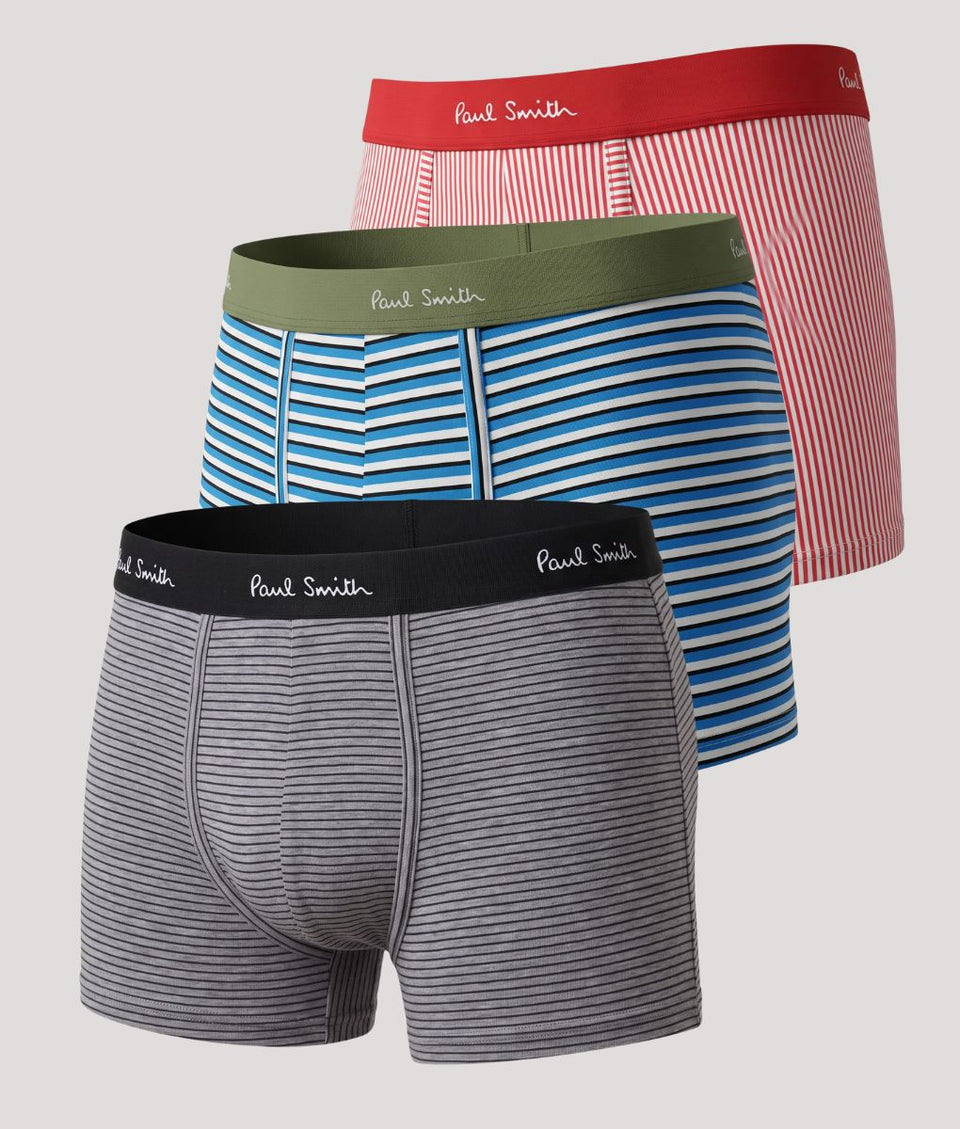 Three pairs of Paul Smith men's boxer briefs displayed together on a light gray background. The set includes a gray and black striped pair in front, a blue and white striped pair in the middle with an olive green waistband, and a red and white striped pair in back with a red waistband.