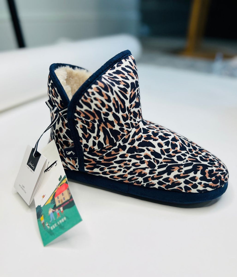 Leopard print boot with a tag on a white surface