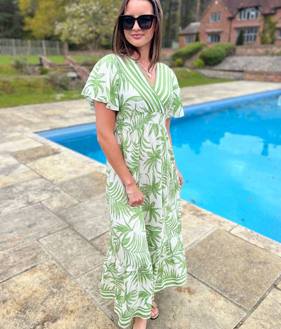 Sundress with a green pretty boho floral print worn on a summers day